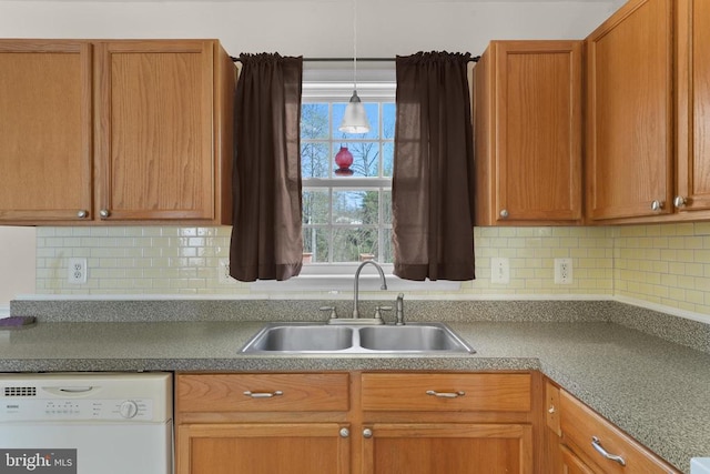 kitchen featuring white dishwasher, a sink, decorative backsplash, pendant lighting, and brown cabinets