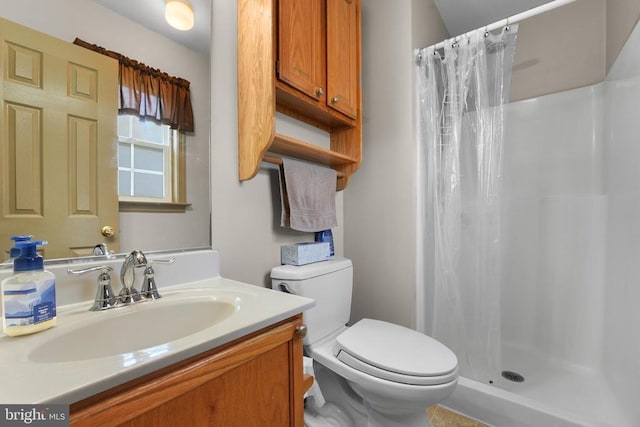 bathroom featuring curtained shower, toilet, and vanity