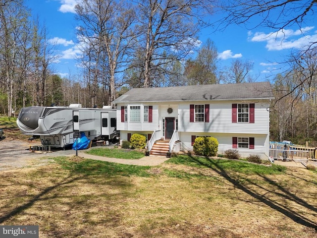 raised ranch with a front lawn