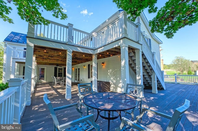 315 Ganders Dr, Luray, VA 22835 - rear view of house with metal roof, a wooden deck, outdoor dining area, stairway, and a standing seam roof