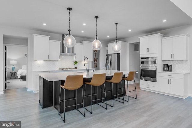 10115 Premier St, Fredericksburg, VA 22408 - kitchen with appliances with stainless steel finishes, a sink, wall chimney range hood, tasteful backsplash, and light countertops
