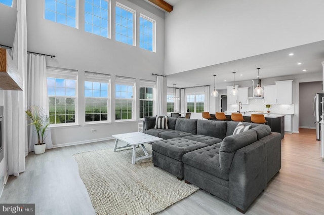 10115 Premier St, Fredericksburg, VA 22408 - living room with light wood-style flooring, a towering ceiling, recessed lighting, and baseboards