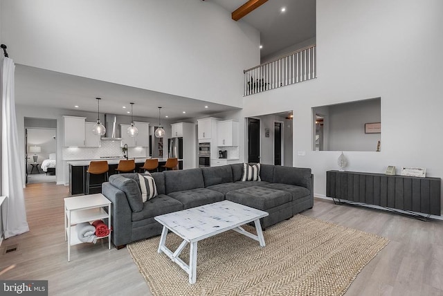 10115 Premier St, Fredericksburg, VA 22408 - living area with light wood-style flooring, a high ceiling, and beamed ceiling