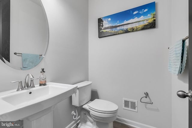 10115 Premier St, Fredericksburg, VA 22408 - bathroom with toilet, a sink, and baseboards