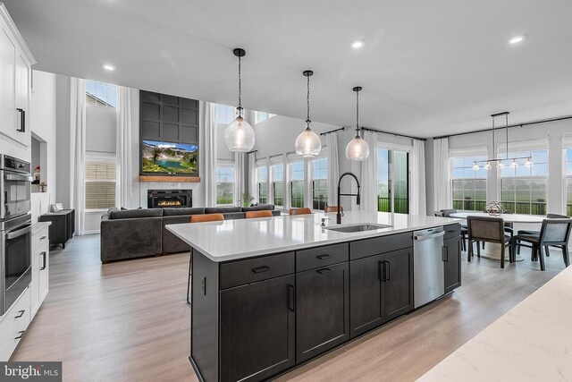 10115 Premier St, Fredericksburg, VA 22408 - kitchen featuring a sink, appliances with stainless steel finishes, white cabinetry, light wood-style flooring, and recessed lighting