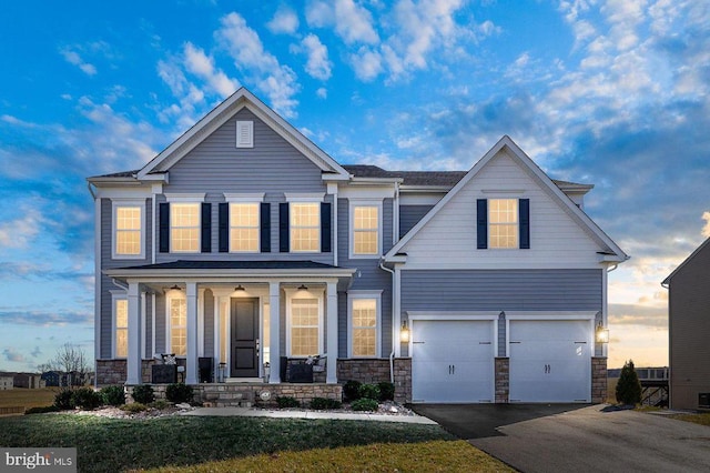 10115 Premier St, Fredericksburg, VA 22408 - view of front of house featuring covered porch, an attached garage, asphalt driveway, and stone siding