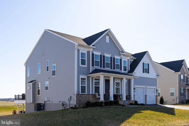 10115 Premier St, Fredericksburg, VA 22408 - view of front facade with an attached garage, a front yard, covered porch, concrete driveway, and central air condition unit