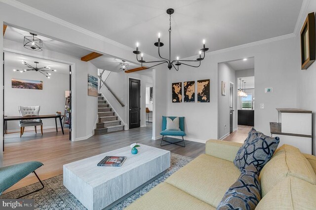 10115 Premier St, Fredericksburg, VA 22408 - living room featuring a chandelier, stairs, wood finished floors, baseboards, and crown molding