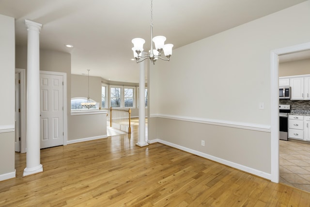 173 Valley View Ave, Mount Sidney, VA 24467 - unfurnished dining area with ornate columns, light wood finished floors, a chandelier, recessed lighting, and baseboards