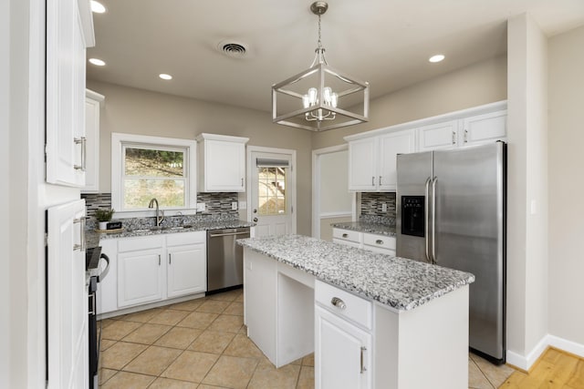 173 Valley View Ave, Mount Sidney, VA 24467 - kitchen featuring appliances with stainless steel finishes, a kitchen island, a chandelier, a sink, and backsplash