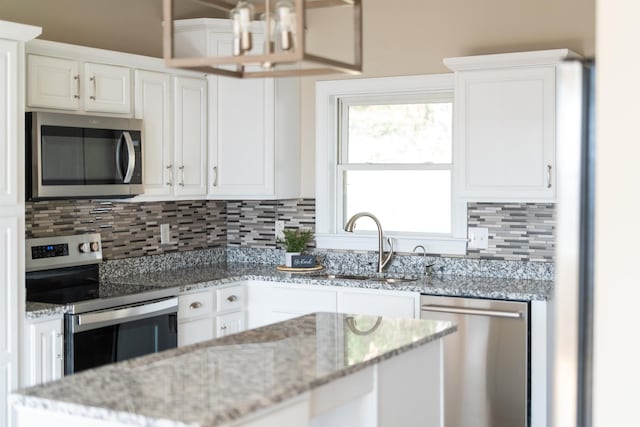 173 Valley View Ave, Mount Sidney, VA 24467 - kitchen featuring appliances with stainless steel finishes, tasteful backsplash, white cabinets, and a chandelier