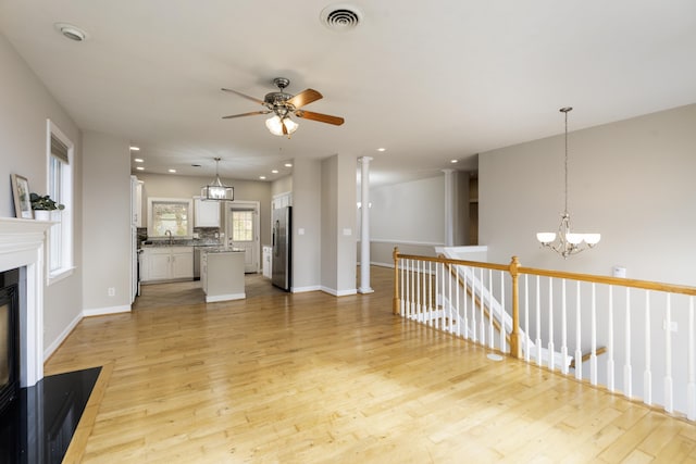 173 Valley View Ave, Mount Sidney, VA 24467 - unfurnished living room with light wood-style flooring, a chandelier, ceiling fan, recessed lighting, and a sink