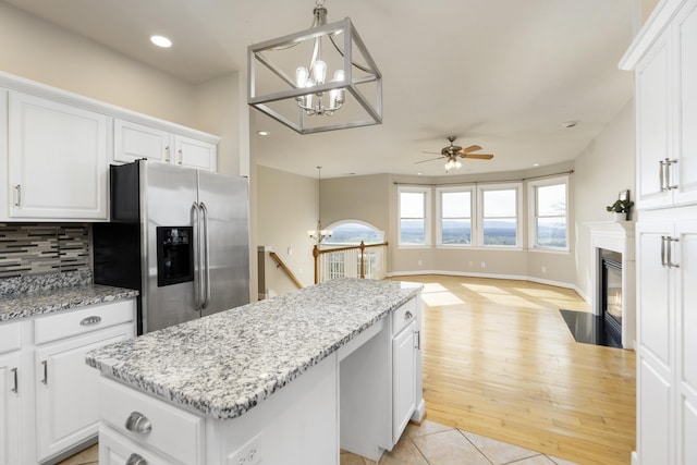 173 Valley View Ave, Mount Sidney, VA 24467 - kitchen featuring stainless steel fridge with ice dispenser, a kitchen island, ceiling fan, white cabinets, and tasteful backsplash