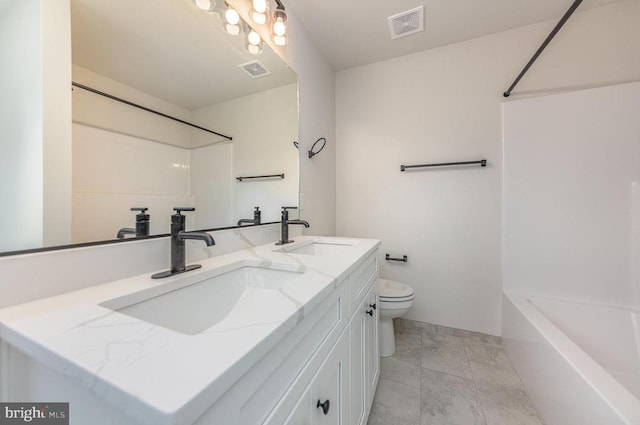 full bath with toilet, double vanity, and bathtub / shower combination
