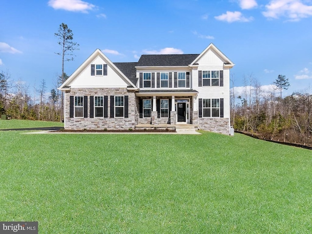rear view of house with a porch, stone siding, a yard, and board and batten siding