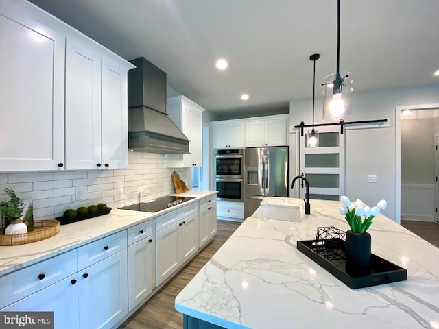 kitchen featuring stainless steel appliances, a sink, custom range hood, decorative backsplash, and white cabinetry