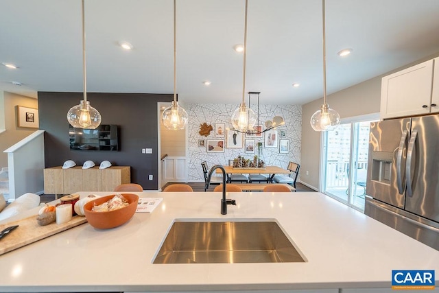 3018 Horizon Rd, Charlottesville, VA 22902 - kitchen with stainless steel fridge with ice dispenser, a sink, light countertops, white cabinetry, and pendant lighting