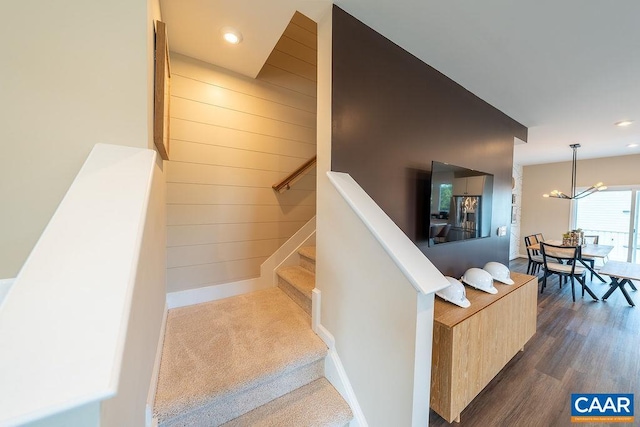 3018 Horizon Rd, Charlottesville, VA 22902 - staircase with a chandelier, wood walls, wood finished floors, recessed lighting, and baseboards