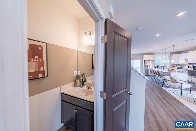 3018 Horizon Rd, Charlottesville, VA 22902 - bathroom with vanity, wood finished floors, recessed lighting, and decorative backsplash
