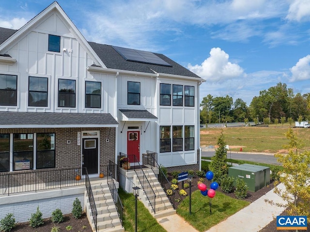 3018 Horizon Rd, Charlottesville, VA 22902 - view of front of house featuring board and batten siding, solar panels, and a shingled roof