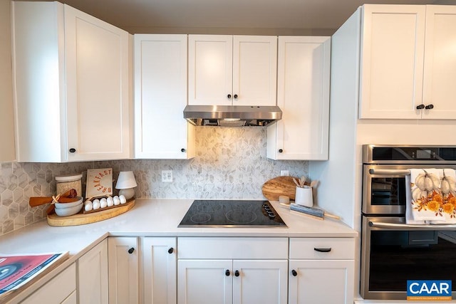 3018 Horizon Rd, Charlottesville, VA 22902 - kitchen with stainless steel double oven, black electric stovetop, under cabinet range hood, light countertops, and white cabinetry
