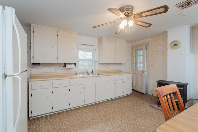 56 Grindstone Rd, Bridgewater, VA 22812 - kitchen with freestanding refrigerator, a sink, ceiling fan, and white cabinets