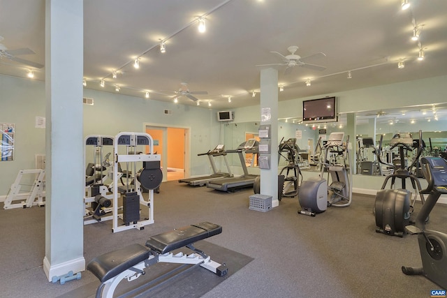 gym featuring rail lighting, visible vents, and ceiling fan