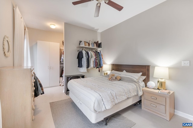 bedroom with ceiling fan and a closet