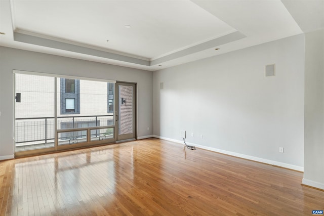 112 5th St SE Unit 3D, Charlottesville, VA 22902 - unfurnished room with a raised ceiling, hardwood / wood-style floors, ornamental molding, and baseboards