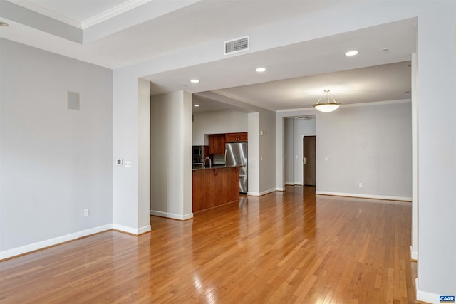 112 5th St SE Unit 3D, Charlottesville, VA 22902 - unfurnished living room featuring crown molding, light wood-style flooring, baseboards, recessed lighting, and a sink