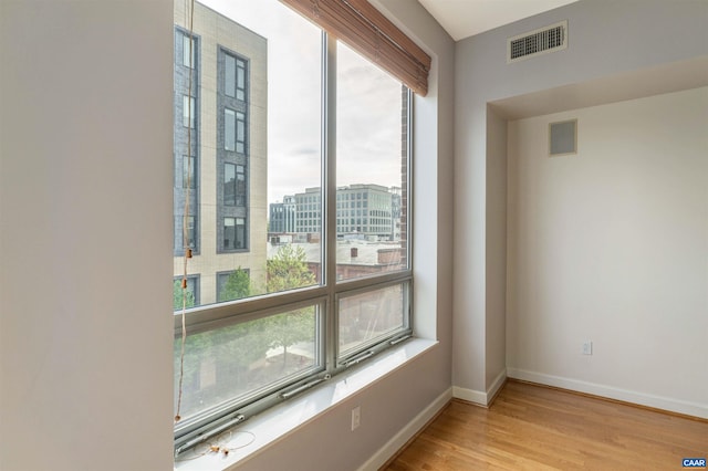 112 5th St SE Unit 3D, Charlottesville, VA 22902 - unfurnished room featuring healthy amount of natural light, baseboards, and light wood finished floors