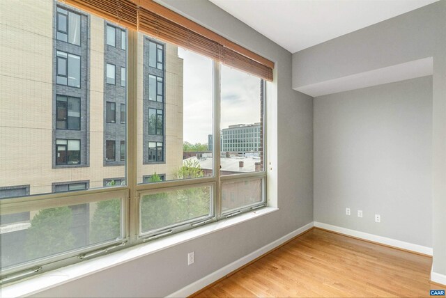 112 5th St SE Unit 3D, Charlottesville, VA 22902 - empty room with baseboards and wood finished floors