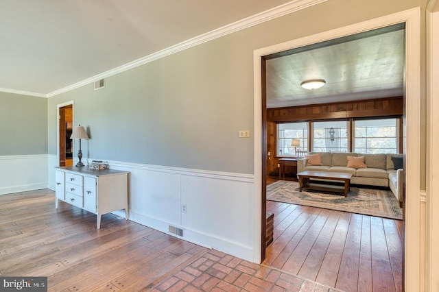 interior space featuring light hardwood / wood-style flooring and ornamental molding