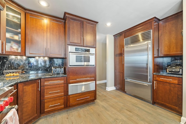 23 Joy Ln, Fishersville, VA 22939 - kitchen featuring appliances with stainless steel finishes, a warming drawer, tasteful backsplash, baseboards, and dark stone countertops