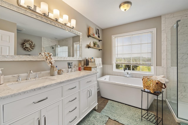 23 Joy Ln, Fishersville, VA 22939 - bathroom featuring a tile shower, a freestanding bath, double vanity, a wainscoted wall, and tile patterned flooring