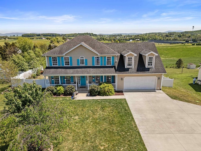 23 Joy Ln, Fishersville, VA 22939 - colonial home with a porch, concrete driveway, a mountain view, roof with shingles, and an attached garage