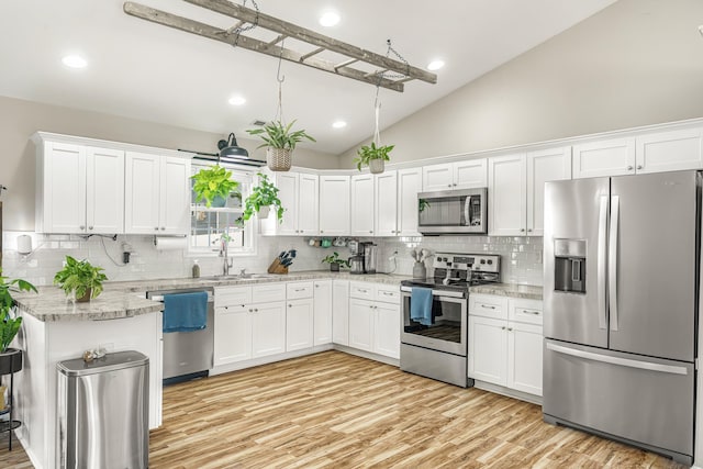 96 Lofty Cir, Stuarts Draft, VA 24477 - kitchen featuring stainless steel appliances, lofted ceiling, backsplash, white cabinetry, and recessed lighting