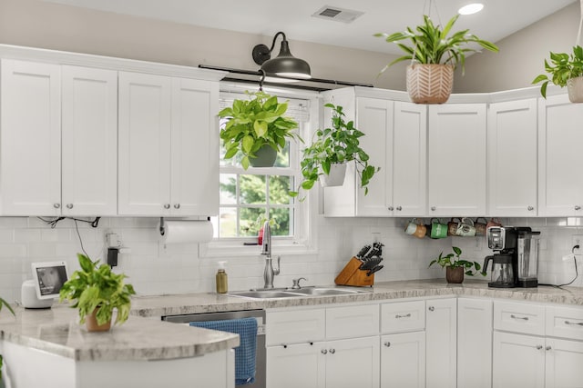 96 Lofty Cir, Stuarts Draft, VA 24477 - kitchen with stainless steel dishwasher, white cabinetry, and tasteful backsplash