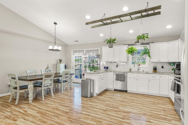 96 Lofty Cir, Stuarts Draft, VA 24477 - kitchen with stainless steel dishwasher, vaulted ceiling, light wood-style floors, a chandelier, and decorative backsplash