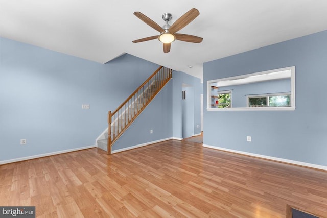 55 Sire Way, Warrenton, VA 20186 - unfurnished living room with stairway, a ceiling fan, and wood finished floors