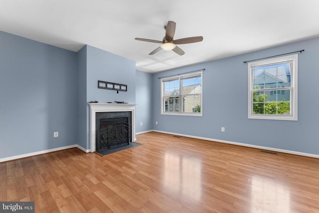 55 Sire Way, Warrenton, VA 20186 - unfurnished living room with wood finished floors, a ceiling fan, and a fireplace with flush hearth