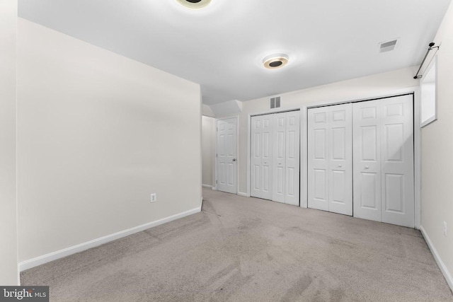 55 Sire Way, Warrenton, VA 20186 - unfurnished bedroom featuring multiple closets and carpet flooring
