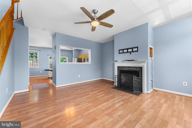 55 Sire Way, Warrenton, VA 20186 - unfurnished living room featuring ceiling fan, a fireplace with flush hearth, and wood finished floors