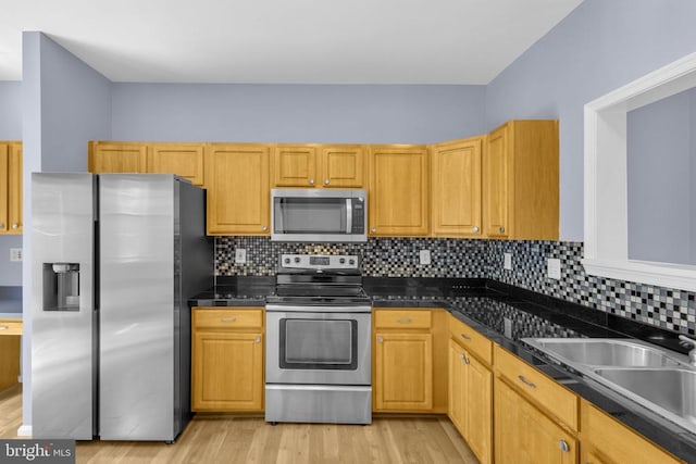 55 Sire Way, Warrenton, VA 20186 - kitchen featuring stainless steel appliances, dark countertops, light wood-style floors, and backsplash