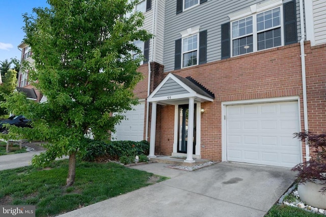 55 Sire Way, Warrenton, VA 20186 - view of front of home with driveway, brick siding, and an attached garage