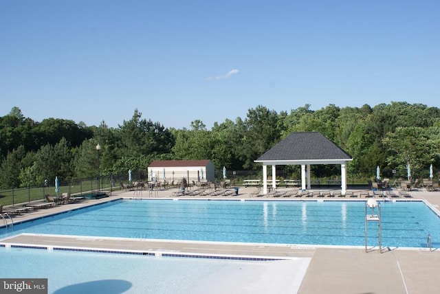 9528 Fall Haven Rd, Fredericksburg, VA 22407 - community pool with fence, a patio area, and a forest view