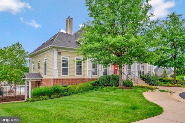 9528 Fall Haven Rd, Fredericksburg, VA 22407 - view of front of home with brick siding, a chimney, and roof with shingles