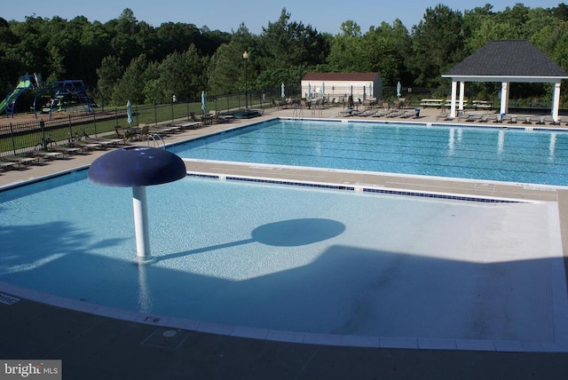9528 Fall Haven Rd, Fredericksburg, VA 22407 - community pool with fence, a patio area, a gazebo, and a wooded view