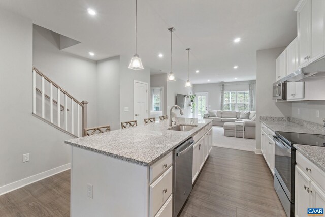 712 Empire St, Charlottesville, VA 22901 - kitchen featuring stainless steel appliances, open floor plan, a center island with sink, white cabinetry, and recessed lighting