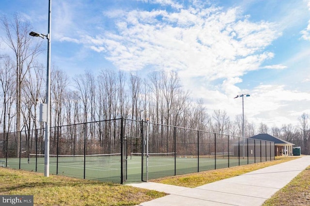 view of tennis court featuring fence
